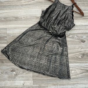 Gorgeous black and gold dress with scalloped details on arm openings.